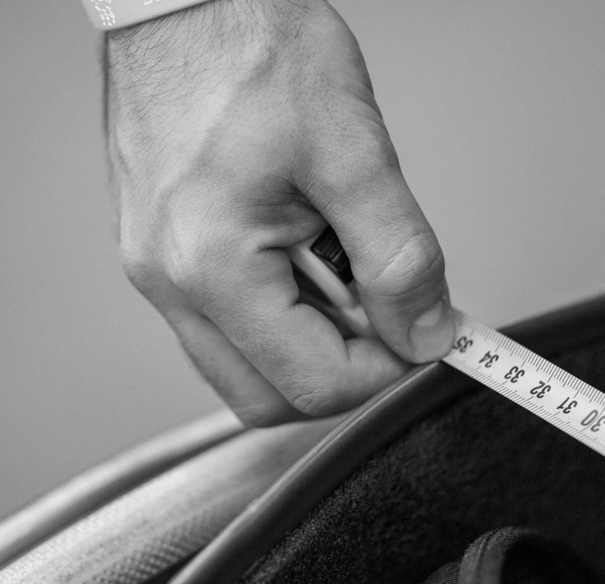 Quality control: measuring a seat with a tape